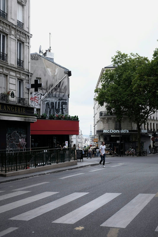 A parisian street scene with buildings and a crosswalk