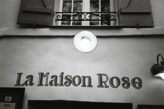 La maison rose sign on a building wall