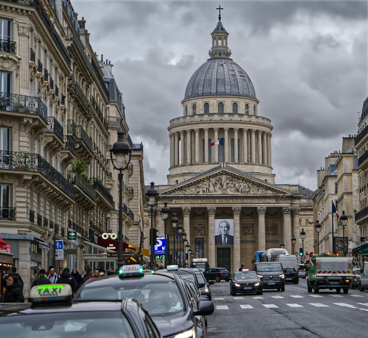 The pantheon in paris with a busy street and cars